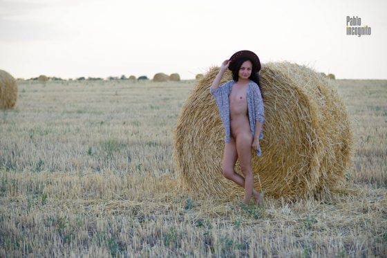 Naked in a hat in the hay