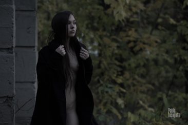 Naked witch in a black cloak photo
