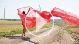 Video of a nude photo shoot. Naked girl in a transparent fabric in the wind. Pablo Incognito