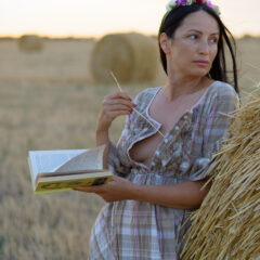 The girl in the hay poses for the photographer. Glamor, nude. She unbuttoned her dress. Nude photo by Pablo Incognito