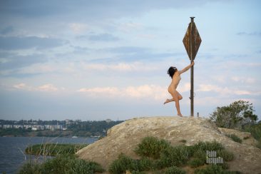 Naked dancing around a metal pole