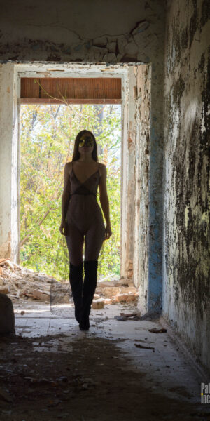 A girl in a transparent dress and a mask poses at the old airport. Nude photo by Pablo Incognito