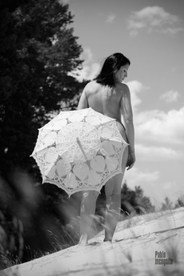 Nude woman covered herself with an umbrella