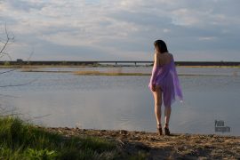 A girl in a transparent poncho on the bank of the estuary. Nude photo by Pablo Incognito