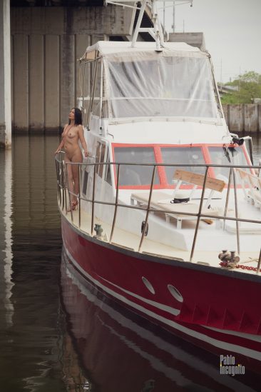 Nude model posing on a pleasure boat