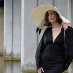 A girl in a chic hat and a little black dress. Photo by Pablo Incognito
