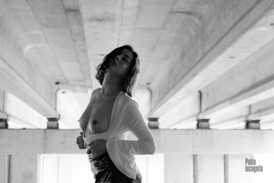 Passionate topless under the bridge, bw photo