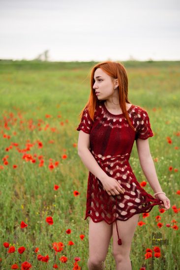Red-haired girl in a short knitted dress