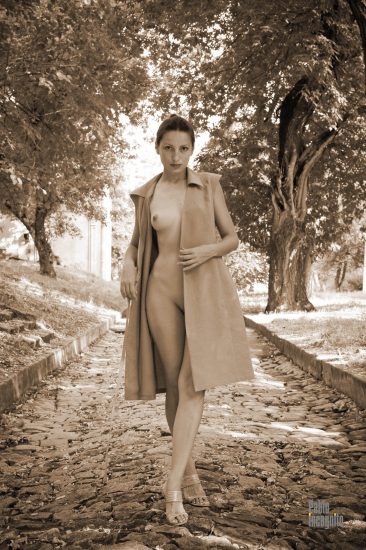 Retro nude, the girl unbuttoned her dress and walks along the road