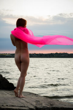 Naked beauty posing in the evening, the wind develops the fabric, photo