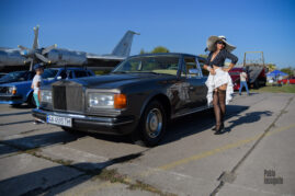 A girl in stockings near an old car at an exhibition in Kiev, photo