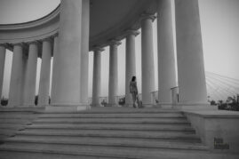 Naked girl walking among the columns, nude black and white