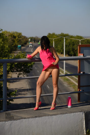 Pretty woman arranged bottomless on the bridge over the highway, photo