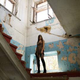 Young girl in a a transparent dress on the stairs nude photo