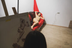 Model posing nude in the artist's studio photo backstage
