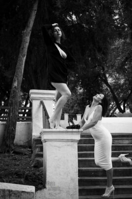Two girls posing for nude photographer in the park