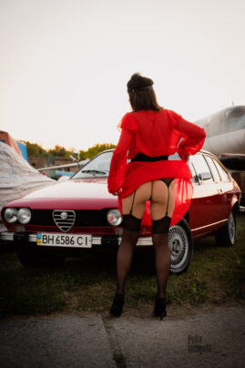 The wind lifted her skirt and bared her legs in stockings with a belt nude photo