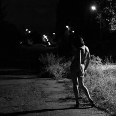 Naked girl in the light of a street lamp at night. Photographer Pablo Incognito