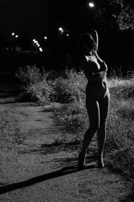 Night nude photo session under a lantern