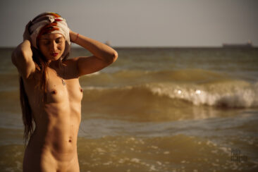 Naked in a wrapped headscarf on the sea beach nude