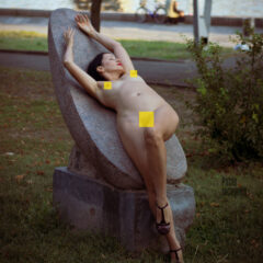 Nude photo session on the embankment. Naked girl on a stone. Photographer Pablo Incognito