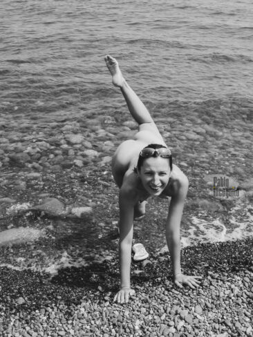Nudist posing for photographer on the beach