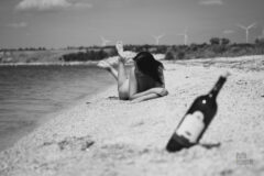 Nudist sunbathing on a deserted beach nude