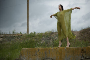 Woman in a transparent cape catches the wind with her hands, nude photo by Pablo Incognito