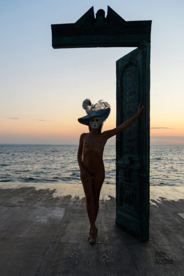 Nude House of the Sun, naked in a mask by the sea