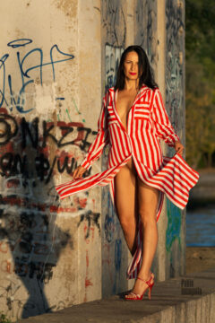 A girl in a red striped dress poses for a nude photographer Pablo Incognito