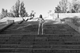 Nude nude model Irene Adler poses naked on the city stairs in the center