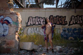 Nude photo session on the ruins with graffiti