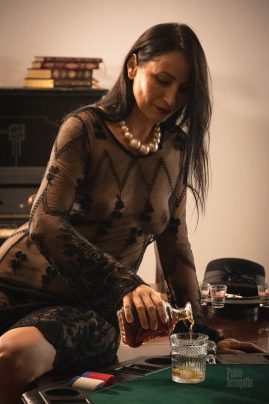 Iren Adler pouring whiskey