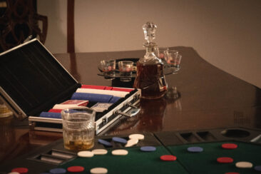 Case with poker chips and decanter of whiskey